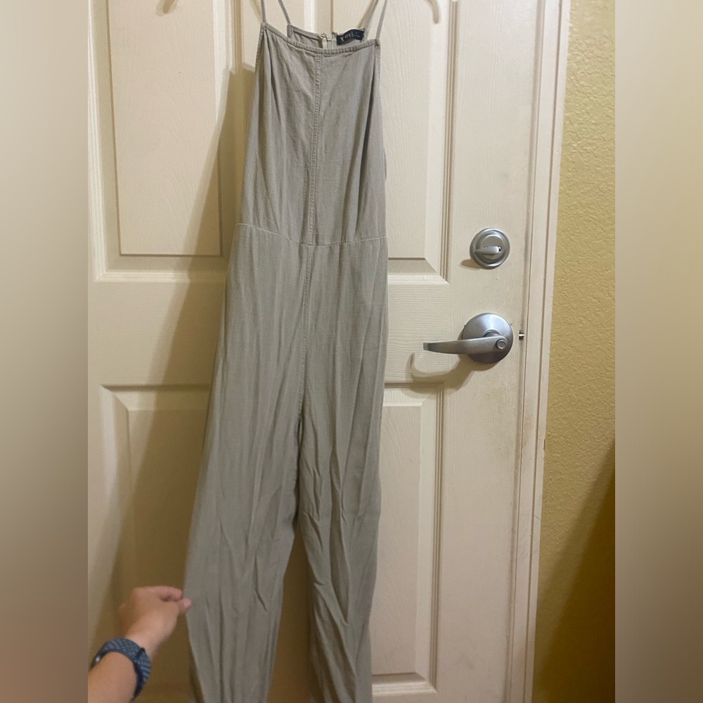 tan jumpsuit with a zipper and tie in the back